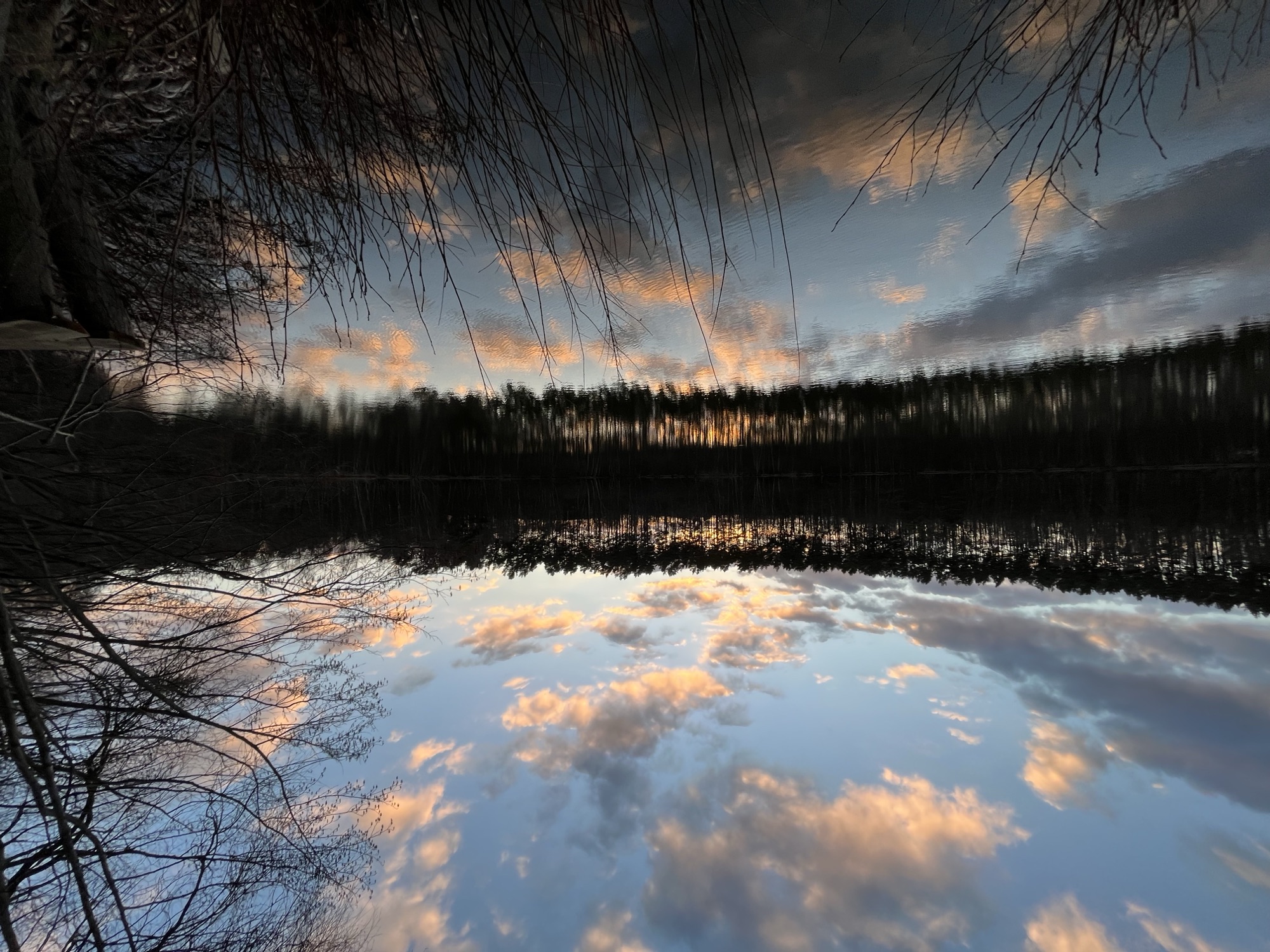 Abendwolken spiegeln sich im stillen Wasser